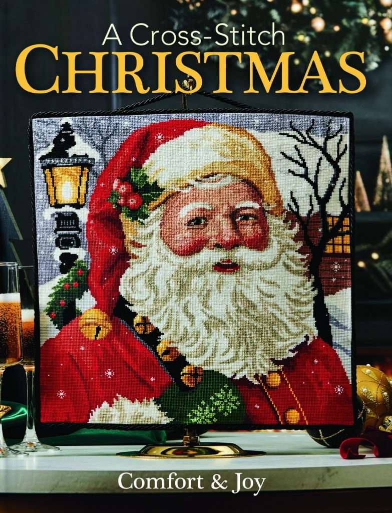 2025 Cross-Stitch Christmas cover image of a smiling Santa portrait.
